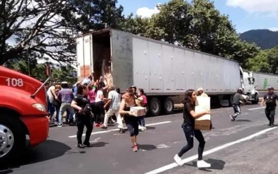 Pobladores rapiñan zapatos y ropa tras choque de tráiler en la Puebla-Córdoba